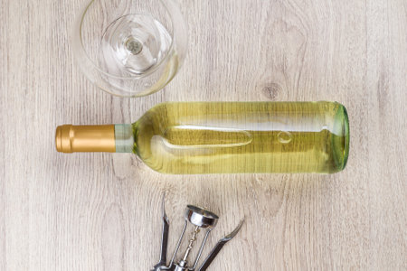 Wine bottle with corkscrew on wooden background.の写真素材