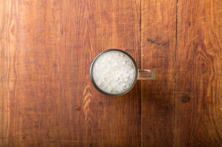 glass of fresh lager beer on wooden table.
