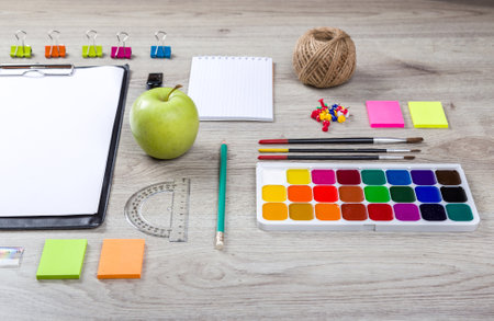 school supplies with pencils, paint pens paper scissors and rulers.