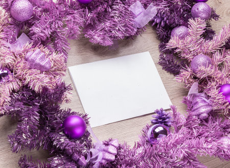 Magenta christmas wreath with blank card on wood background.の写真素材