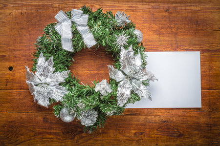 Green christmas wreath with card decorations on wood background.の写真素材