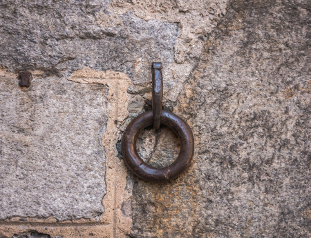 Old sandstone wall with a single metal ring.の写真素材
