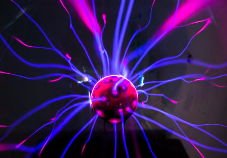 Plasma ball  with magenta-blue flames on a black background.