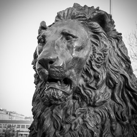 Metal Lion Statue rests on a stone pedestalの写真素材