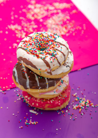 Donuts with icing on color background. Sweet donuts. Donuts backgroundの写真素材