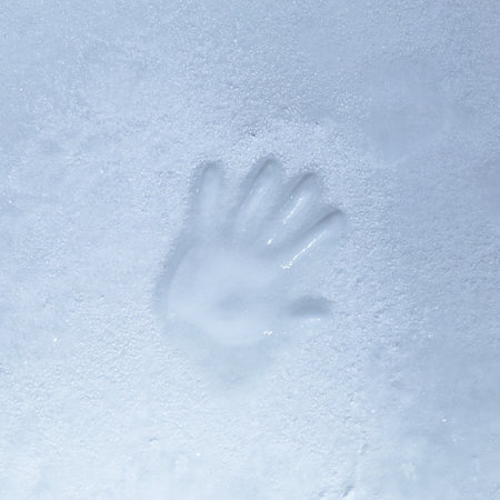 Ice with an impression of a handprint cold tone.の写真素材