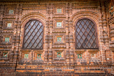 Antique windows in a red brick wall.