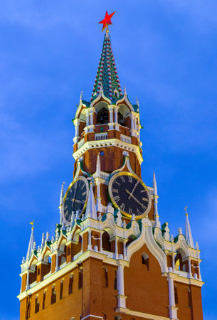 Moscow Kremlin, Red Square. Spasskaya (Savior's) clock tower decorated by the red ruby star on the top of it. Blue sky background.の写真素材