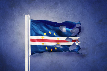 Torn flag of Cape Verde flying against grunge backgroundの写真素材