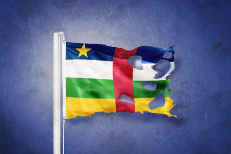 Torn flag of Central African Republic flying against grunge backgroundの写真素材