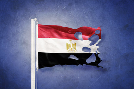 Torn flag of Egypt flying against grunge backgroundの写真素材