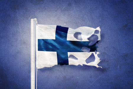 Torn flag of Finland flying against grunge backgroundの写真素材