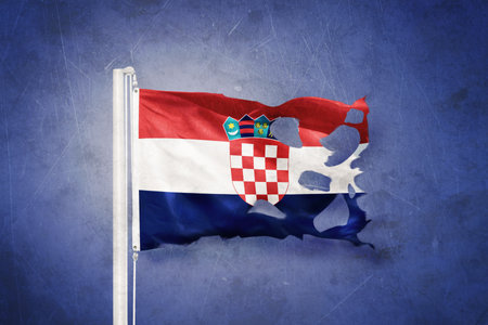 Torn flag of Croatia flying against grunge backgroundの写真素材