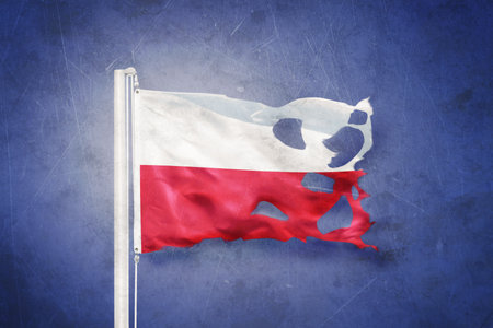 Torn flag of Poland flying against grunge backgroundの写真素材