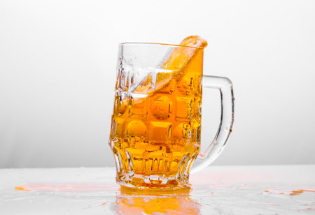 Glass of fresh beer on white backgroundの写真素材