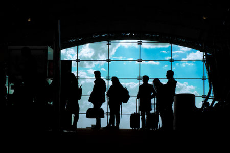 Silhouettes of people waiting for their flight at the airport.の写真素材