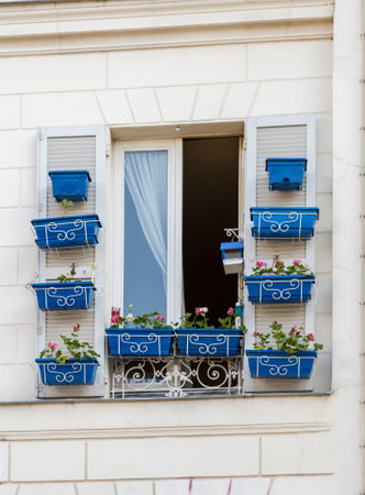 Window frame of house with beautiful flowersの写真素材