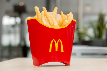 Moscow, Russia, March 15 2018: McDonalds potato french fries in the red box on wooden background