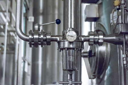 Industrial pressure meter - barometer and water pipes in the background