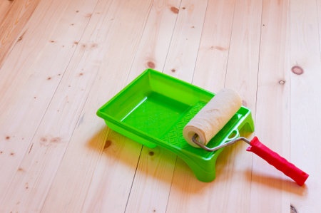 Paint roller brush on wood backgroundの写真素材