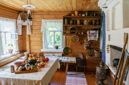 Traditional Russian cottage with oven and crockery. Interior of a peasant hutの写真素材