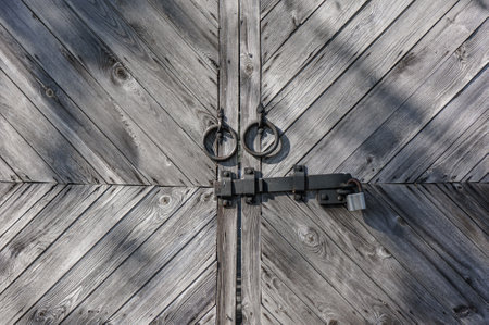 Locked brown old wooden fenceの写真素材