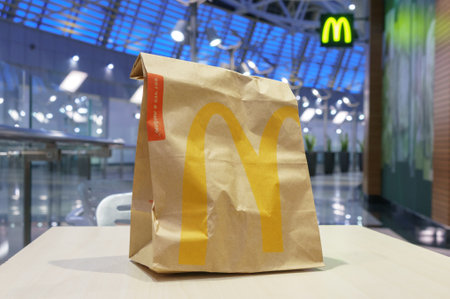 Moscow, Russia - February 07, 2019: McDonaldâs brown paper bag with blurred kiosk in shopping mallのeditorial素材
