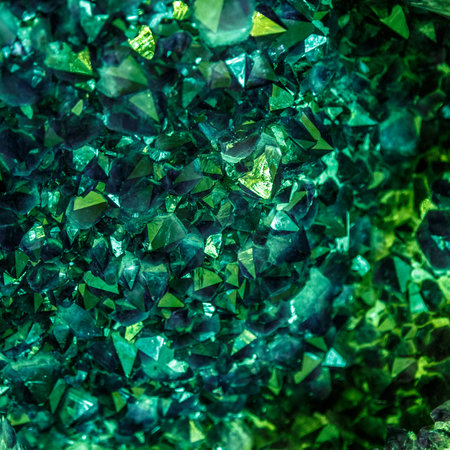 Emerald, Sapphire or Tourmaline green crystals. Gems. Mineral crystals in the natural environment. Stone of precious crystals on white background is insulated. Copy space. Colored shiny bokeh surface.の写真素材