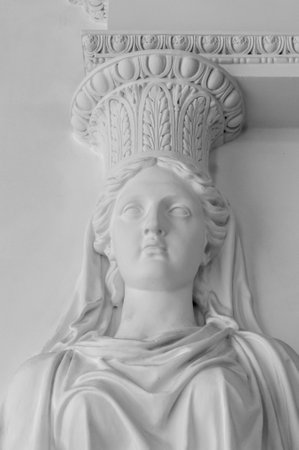 Statue of woman. Marble sculpture female bust. Caryatid stained sculpture adorns the old house facadeの写真素材