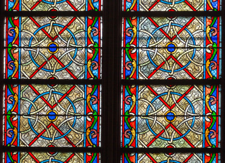 Paris, France, March 27, 2017: Stained glass window at Notre Dame cathedral. Notre Dame church is...