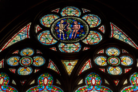 Paris, France, March 27, 2017: Stained glass window at Notre Dame cathedral. Notre Dame church is...