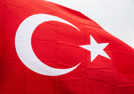 Flag of Turkey waving in the wind with highly detailed fabric texture