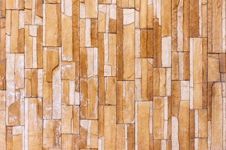 Tile stone wall pattern texture. For background or floor. Fragment of a wall from a chipped stoneの写真素材