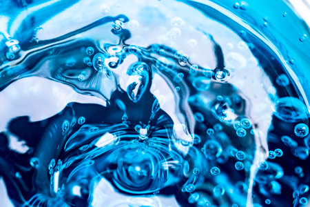 Water blue gel balls. Polymer gel. Silica gel. Balls of blue hydrogel. Crystal liquid ball with reflection. Texture background. Close up macro. Soapsuds background with air bubblesの写真素材