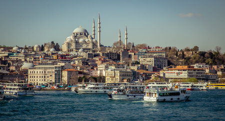 Istanbul, Turkey, 22 March 2019: Touristic sightseeing ships in Golden Horn bay of Istanbul and view on Suleymaniye mosque from the Golden Horn metro Bridgeのeditorial素材