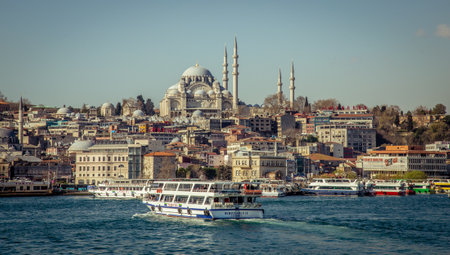 Istanbul, Turkey, 22 March 2019: Touristic sightseeing ships in Golden Horn bay of Istanbul and view on Suleymaniye mosque from the Golden Horn metro Bridgeのeditorial素材