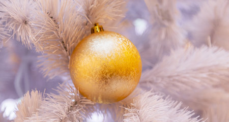 Christmas tree with silver bauble ornaments. Decorated Christmas tree closeup. Balls and illuminated garland with flashlights. New Year baubles macro photo with bokeh. Winter holiday light decorationの写真素材