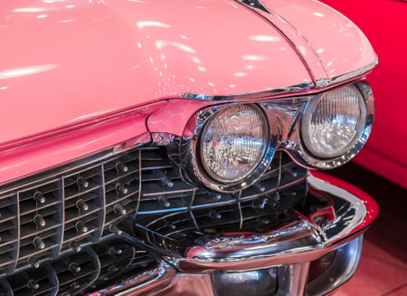 Istanbul, Turkey, 23 March 2019: Close-up photo of pink Cadillac de Ville. Detail on the headlight of vintage classic car. Selective focus. Pink retro car in Rahmi M. Koc Industrial Museumのeditorial素材