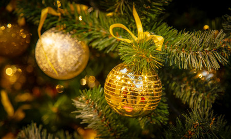 Christmas tree with silver bauble ornaments. Decorated Christmas tree closeup. Balls and illuminated garland with flashlights. New Year baubles macro photo with bokeh. Winter holiday light decorationの写真素材