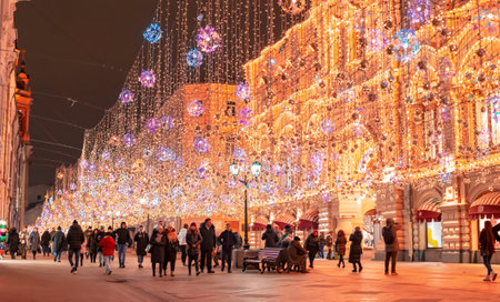 Moscow, Russia - November 27, 2019: Golden colorful rain of Christmas decorations hanging from the sky, on Nikolskaya street next to GUM in the capital. Nikolskaya street illuminated. Beautiful lightsのeditorial素材