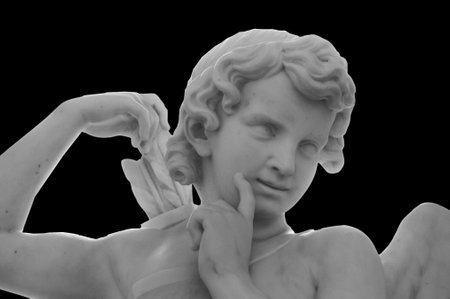 White angel of death against black background as a symbol of the end of life. Ancient statue....
