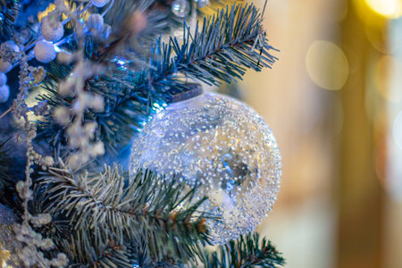 Big blue glass bsll on Christmas tree. Merry xmas and Happy New Year clise-up background. Ballの写真素材