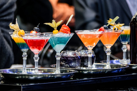 Many alcoholic drink glass at the festive reception. Alcoholic cocktail in glasses decorated with...
