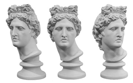 White gypsum copy of ancient statue of Apollo God of Sun head isolated on a white background....