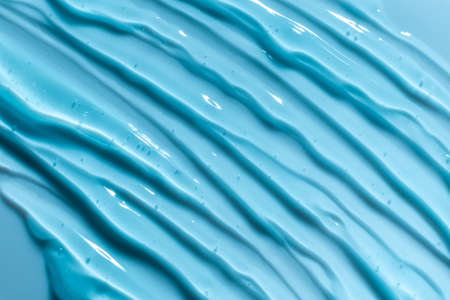 Blue gel texture. Hand sanitizer, alcohol gel background. Cosmetic clear liquid cream smudge....