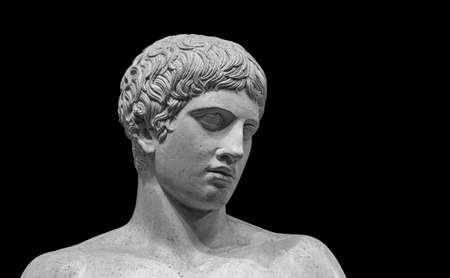 The Doryphoros statue. Roman marble copy of ancient classic greek contrapposto statue isolated on a black background.の写真素材