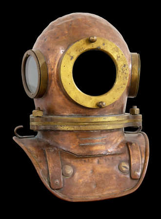 Old antique metal scuba helmet isolated on black backgroundの写真素材