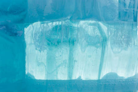 Ice block wall as texture or background. Cold frost transparent bricks pattern