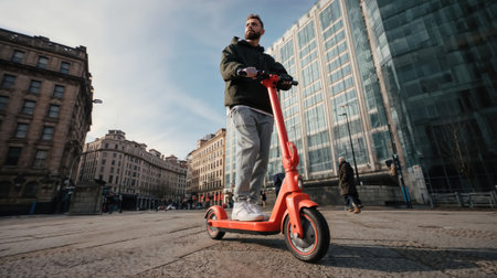 A young man on an orange electric scooter rides through a bustling city street, a modern urban explorer.の素材
