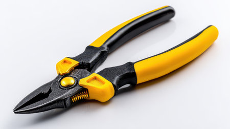 Professional slip joint pliers with yellow and black ergonomic handles isolated on white background for construction and repair work.の素材
